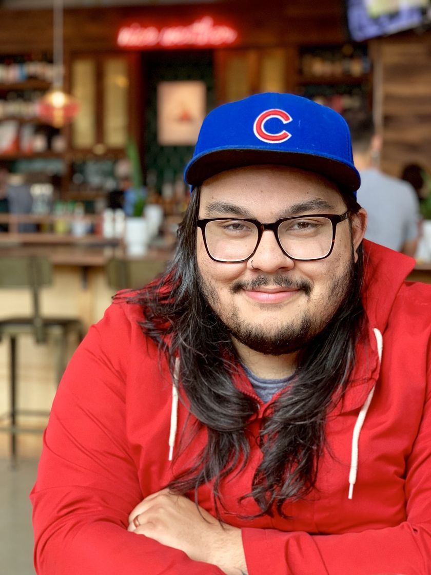 Trevor in a Cubs cap and red hoodie